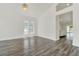 Open living room featuring hardwood floors, neutral walls, and bright windows at 2525 Sand Arbor Cir, Orlando, FL 32824