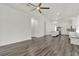 Open living room showcases an archway, view of the modern kitchen, and lots of natural light at 2525 Sand Arbor Cir, Orlando, FL 32824
