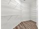 Spacious walk-in closet with custom shelving and laminate floors, offering ample storage at 2525 Sand Arbor Cir, Orlando, FL 32824