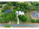 Aerial view of a beautiful home with a pool, long driveway, and serene pond at 260 Country Circle W Dr, Port Orange, FL 32128
