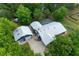 Aerial view of a home featuring a screened-in pool, metal roof and garage with ample yard space at 260 Country Circle W Dr, Port Orange, FL 32128