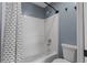Bright bathroom featuring a shower with patterned curtain and standard toilet at 260 Country Circle W Dr, Port Orange, FL 32128