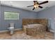 Bathroom featuring a tiled jacuzzi tub, toilet, and window view at 260 Country Circle W Dr, Port Orange, FL 32128