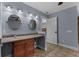 Bathroom with dual sinks, granite countertop, wood cabinet, and large mirrors for a luxurious feel at 260 Country Circle W Dr, Port Orange, FL 32128