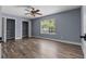 Bedroom featuring hardwood floors, natural light, neutral paint, and a closet at 260 Country Circle W Dr, Port Orange, FL 32128