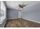 This bedroom features hardwood floors, natural light, neutral paint and a closet at 260 Country Circle W Dr, Port Orange, FL 32128