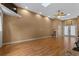 Sunlit bonus room featuring hardwood floors, skylights, and a ceiling fan, creates a versatile space at 260 Country Circle W Dr, Port Orange, FL 32128