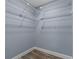Walk-in closet providing ample storage with wire shelving and hardwood floors at 260 Country Circle W Dr, Port Orange, FL 32128