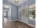 Bright foyer with modern flooring, a window-lined front door, and views leading into the home's spacious, open layout at 260 Country Circle W Dr, Port Orange, FL 32128
