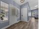 Bright entryway featuring wood-look floors, a decorative front door, and large windows offering ample natural light at 260 Country Circle W Dr, Port Orange, FL 32128