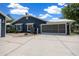 Well-maintained home with a concrete driveway, lush landscaping, and a convenient screened-in garage at 260 Country Circle W Dr, Port Orange, FL 32128