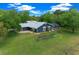 Beautiful home featuring a metal roof, large lawn, and landscaped garden area at 260 Country Circle W Dr, Port Orange, FL 32128