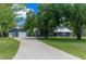 Charming single-story home with a well-manicured lawn, a long driveway, and a detached garage at 260 Country Circle W Dr, Port Orange, FL 32128