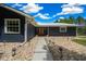 Inviting front entrance with a walkway, manicured rock landscaping, and a charming orange front door at 260 Country Circle W Dr, Port Orange, FL 32128