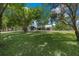 Expansive front lawn of a home with mature trees and a view of the house in the background at 260 Country Circle W Dr, Port Orange, FL 32128