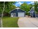 Close up of a detached garage with a paved driveway and a manicured lawn at 260 Country Circle W Dr, Port Orange, FL 32128