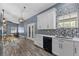 An open-concept kitchen showcasing white cabinets, stainless steel appliances, and an adjacent dining area at 260 Country Circle W Dr, Port Orange, FL 32128