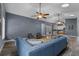 Open-concept living room featuring a comfortable blue sofa, ceiling fans, recessed lighting, and stylish flooring throughout the area at 260 Country Circle W Dr, Port Orange, FL 32128