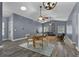 Open-concept living area featuring wood-look floors, a dining area, and comfortable seating, perfect for gatherings and relaxation at 260 Country Circle W Dr, Port Orange, FL 32128
