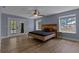 Spacious primary bedroom featuring hardwood floors, a ceiling fan, and access to a screened-in patio at 260 Country Circle W Dr, Port Orange, FL 32128