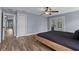 A primary bedroom featuring hardwood floors, a ceiling fan, and sliding doors leading to the backyard pool at 260 Country Circle W Dr, Port Orange, FL 32128
