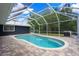 Sparkling screened-in pool with patio, offers a relaxing escape into lush backyard scenery at 260 Country Circle W Dr, Port Orange, FL 32128
