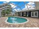 A refreshing screened-in pool enhances outdoor living, adjacent to a spacious patio and house at 260 Country Circle W Dr, Port Orange, FL 32128