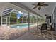 Inviting screened pool with brick patio and ceiling fans is ideal for entertaining and relaxation at 260 Country Circle W Dr, Port Orange, FL 32128