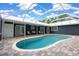 Gorgeous screened-in pool offers a refreshing oasis adjacent to the home's inviting patio at 260 Country Circle W Dr, Port Orange, FL 32128
