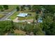 Property with a residence, screened pool, outbuildings and mature trees at 3934 Se 110Th St, Belleview, FL 34420