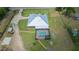 Aerial view of a beautiful home with a pool, lanai, and spacious fenced yard surrounded by mature landscaping at 3934 Se 110Th St, Belleview, FL 34420