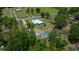 Large lot with a home, pool, and several outbuildings surrounded by trees at 3934 Se 110Th St, Belleview, FL 34420