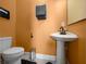 A simple but charming half bath with a classic pedestal sink and tiled floors at 3934 Se 110Th St, Belleview, FL 34420
