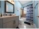 Bathroom with modern vanity and shower with blue and white shower curtain at 3934 Se 110Th St, Belleview, FL 34420