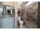 Bathroom with tiled walk-in shower, granite countertop, modern vanity, and updated fixtures for a luxurious feel at 3934 Se 110Th St, Belleview, FL 34420