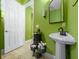 Charming bathroom features a pedestal sink, ample storage, and a bright, cheerful ambiance at 3934 Se 110Th St, Belleview, FL 34420