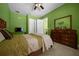 Cozy bedroom with closet access, tiled floor, and a dresser for practical storage solutions at 3934 Se 110Th St, Belleview, FL 34420
