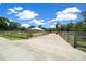 Long driveway leading to a well-maintained home with fenced yard, offering privacy and ample parking at 3934 Se 110Th St, Belleview, FL 34420