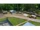 Aerial view of outbuildings including a two car garage, a basketball pad and two sheds at 3934 Se 110Th St, Belleview, FL 34420