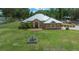 Charming home featuring a fountain in the front yard, arched windows and a well-manicured lawn at 3934 Se 110Th St, Belleview, FL 34420
