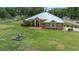 Traditional-style home showcasing a manicured lawn, mature landscaping and a fountain feature at 3934 Se 110Th St, Belleview, FL 34420