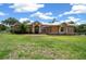 Charming single-story home featuring manicured lawn, neutral colors, and elegant arched windows at 3934 Se 110Th St, Belleview, FL 34420