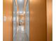 Hallway view leading to a bathroom and featuring light orange walls at 3934 Se 110Th St, Belleview, FL 34420
