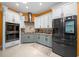 Modern kitchen with stainless appliances, tile backsplash, and ample storage space at 3934 Se 110Th St, Belleview, FL 34420