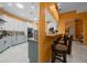 Eat-in kitchen with breakfast bar seating, updated appliances, and modern finishes at 3934 Se 110Th St, Belleview, FL 34420