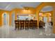 Bright open living area with bar seating and seamless transition into an adjacent kitchen at 3934 Se 110Th St, Belleview, FL 34420