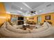 Expansive living room featuring a coffered ceiling, fireplace, and comfortable, sectional seating at 3934 Se 110Th St, Belleview, FL 34420
