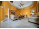 Open-concept living room showcasing high ceilings, tile floors, and modern lighting at 3934 Se 110Th St, Belleview, FL 34420