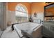Well appointed bathtub area featuring a large tub, unique window, tiled walls, and soft lighting at 3934 Se 110Th St, Belleview, FL 34420