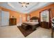 Charming main bedroom with ceiling fan, tiled floor, large window and beautifully coordinated furnishings at 3934 Se 110Th St, Belleview, FL 34420